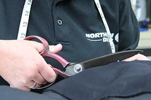 Detail of size adjustments being made to a drysuit